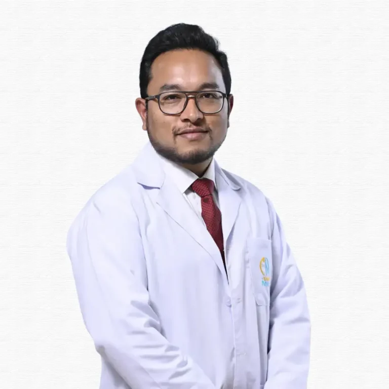 A person in a white coat and red tie stands confidently against a neutral background, conveying professionalism and expertise.